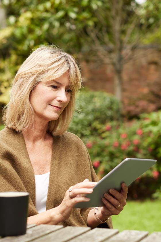 Older woman reading from a tablet