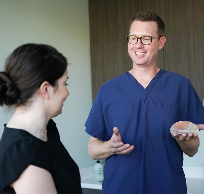 Darrin Hubert MD, FACS discussing breast implants with a patient