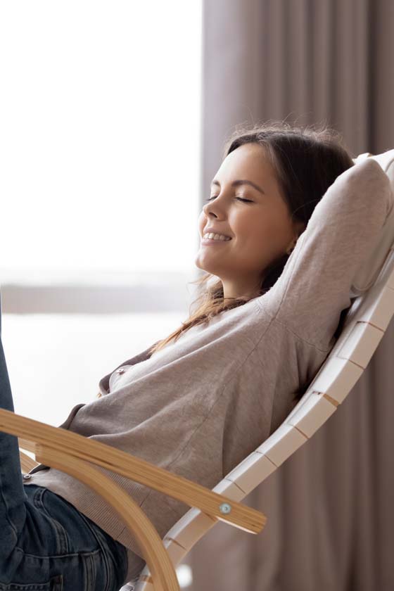 Woman smiling and relaxing in a reclining chair