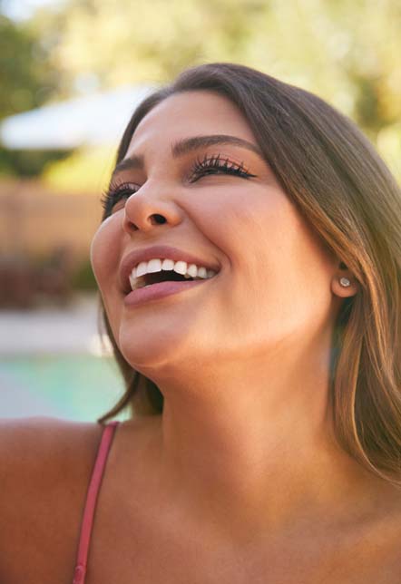 Woman showing off her beautiful smile from a lip lift.