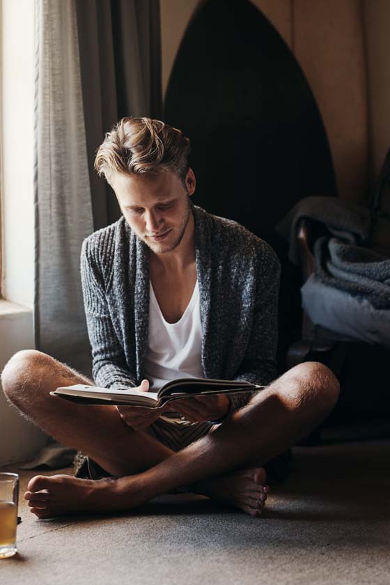 Man relaxing drinking tea and reading a book