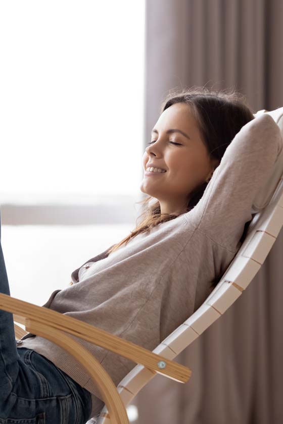 Woman sitting and reclining in a chair